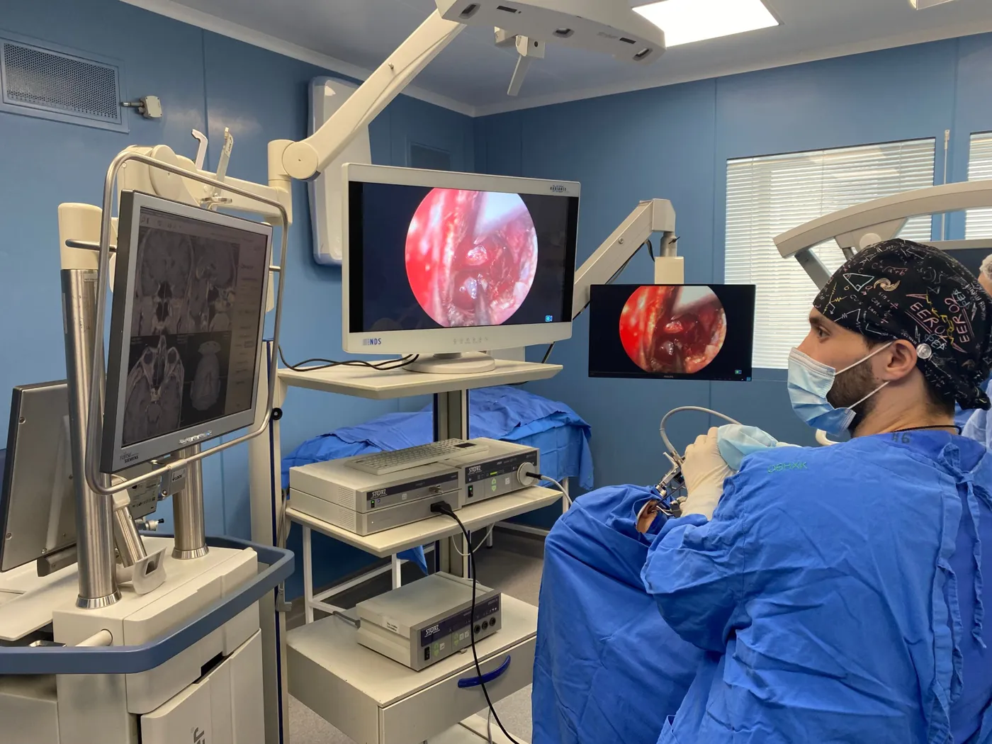 Timur Gasanov during endoscopic surgery, with navigation and endoscope images on the monitors